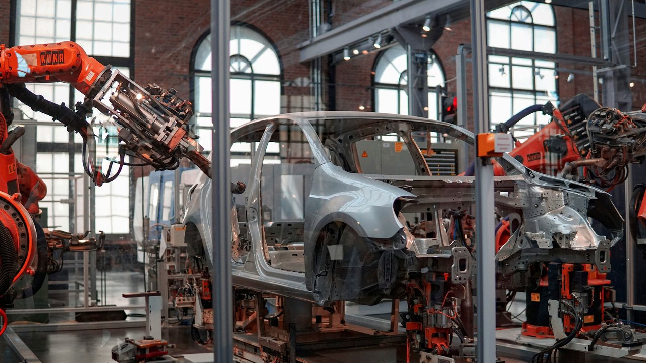 Robotic arms assembling a car body on a production line